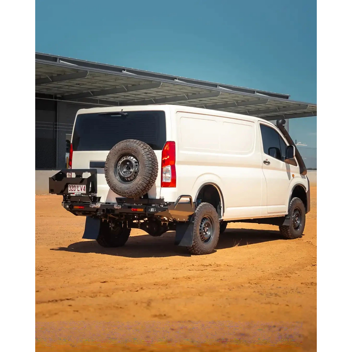 White van with off-road modifications on a dirt road under a clear blue sky – TCC Toyota Hiace 300 Series Rear Bar
