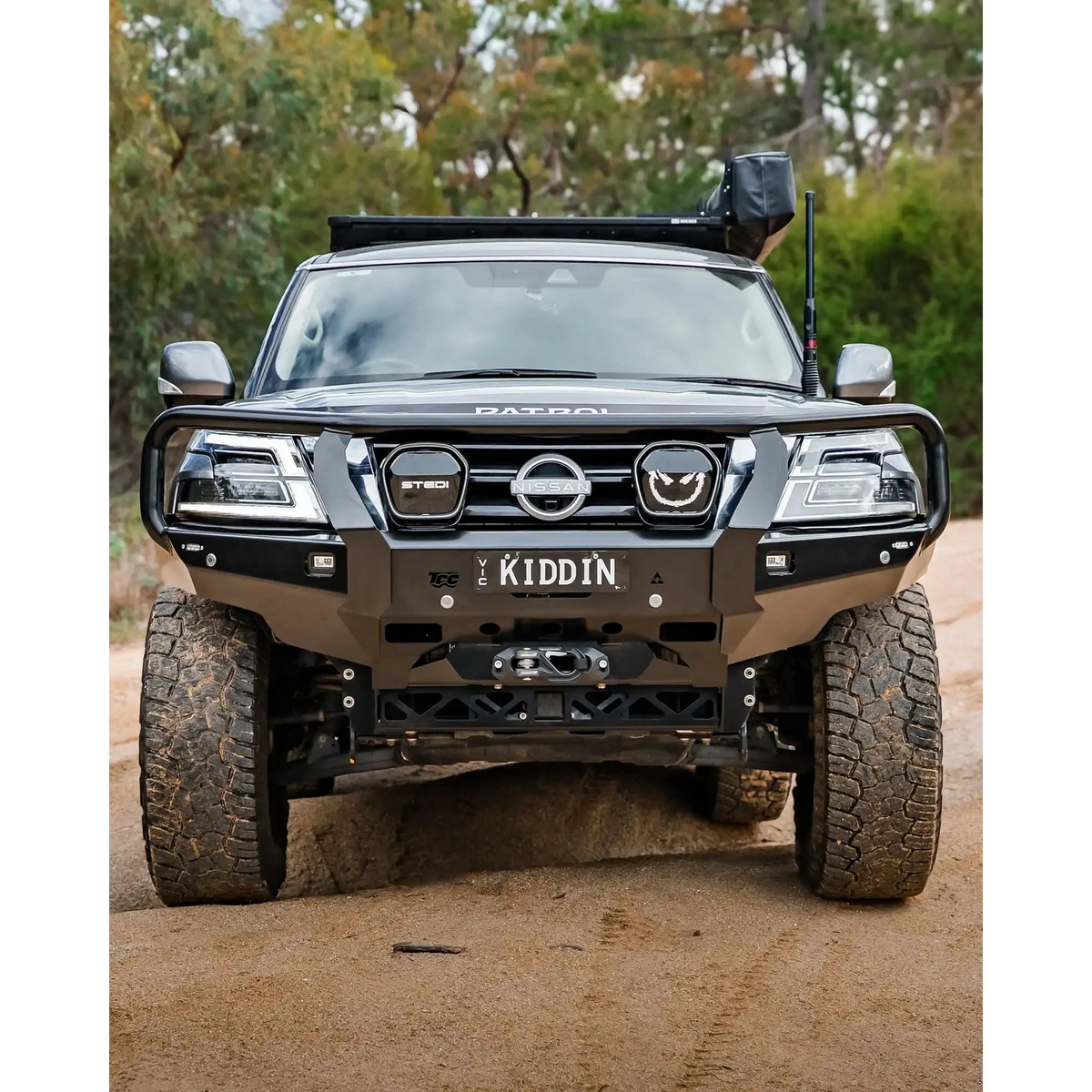 Black Nissan Patrol SUV on a dirt road – TCC Y62 Patrol S5 Bull Bar