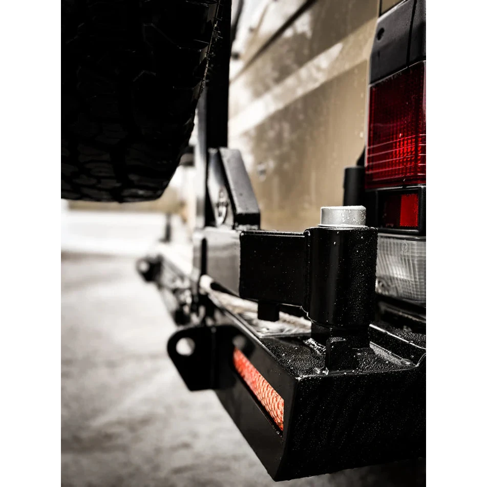 Thorburns LC75/78 Rear Bar – close-up of a vehicle's hitch and trailer attachment on a road.