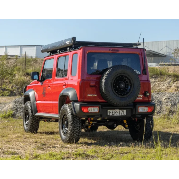 Red Suzuki Jimny XL with off-road tyres and roof rack – Torqit 2.5″ Performance Exhaust for 1.5L Suzuki Jimny XL 01/2024+