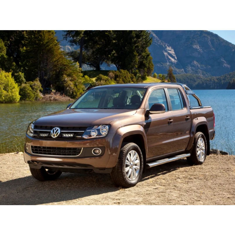 Brown Volkswagen Amarok pickup truck parked by a lake with mountains in the background with Lazer Lamps Grille Kit for VW Amarok (2011–2015)