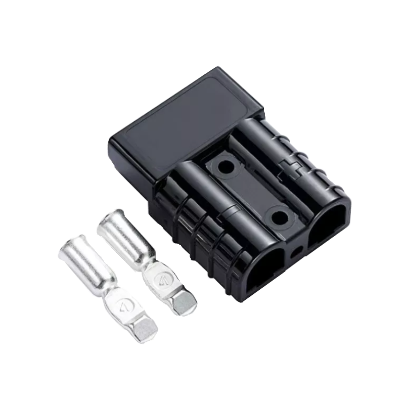 Black Anderson-style 50 amp connector housing at an angle with two silver contacts laid in front, the moulded body showing its two cable cavities and polarity marks