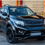 Black Nissan truck parked in front of a building with a red door with Lazer Lamps Nissan Navara (2014-2021) Kit