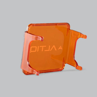 Amber DX4 lens cover seen from behind, the ALTIQ name reading through the translucent panel from the inside face