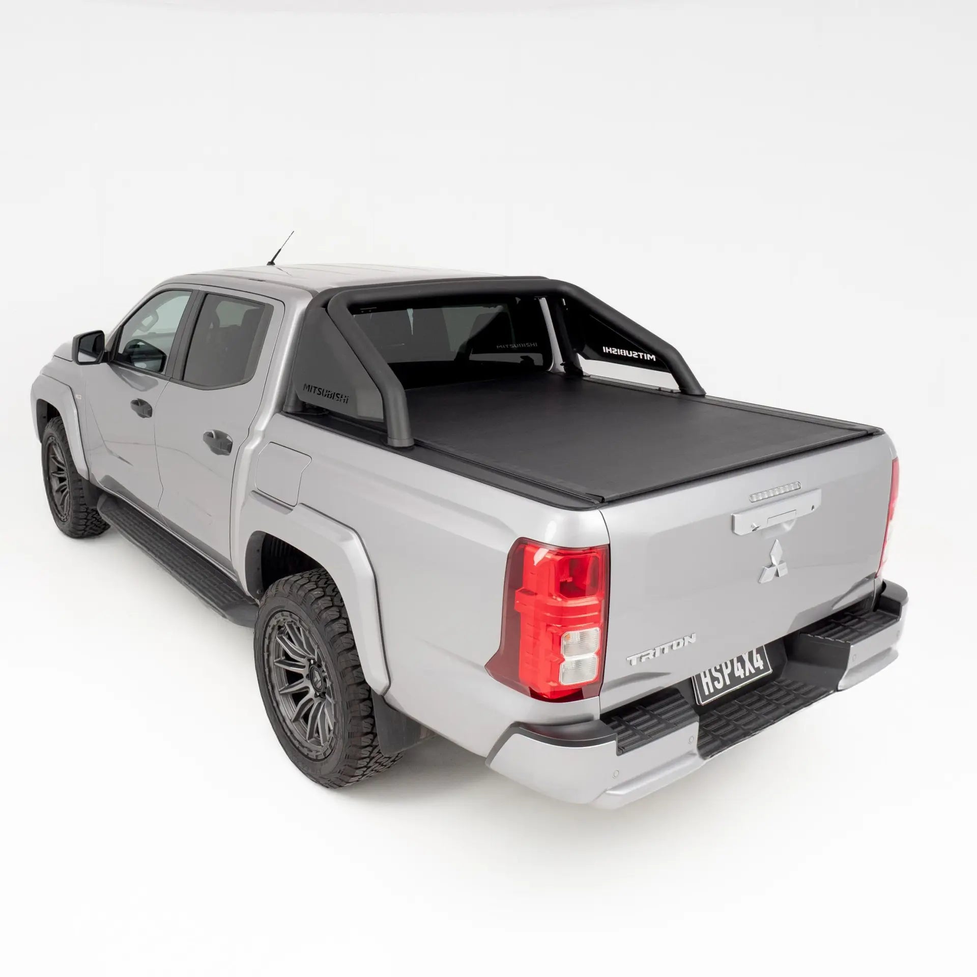 Gray pickup truck with a black tonneau cover on a white background