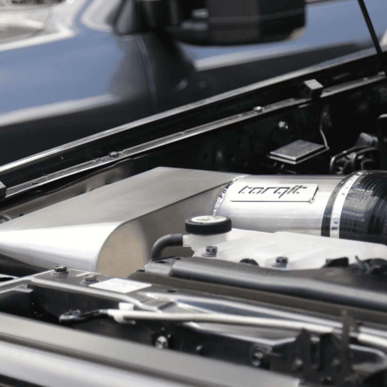 Close-up of a car engine with a branded component.