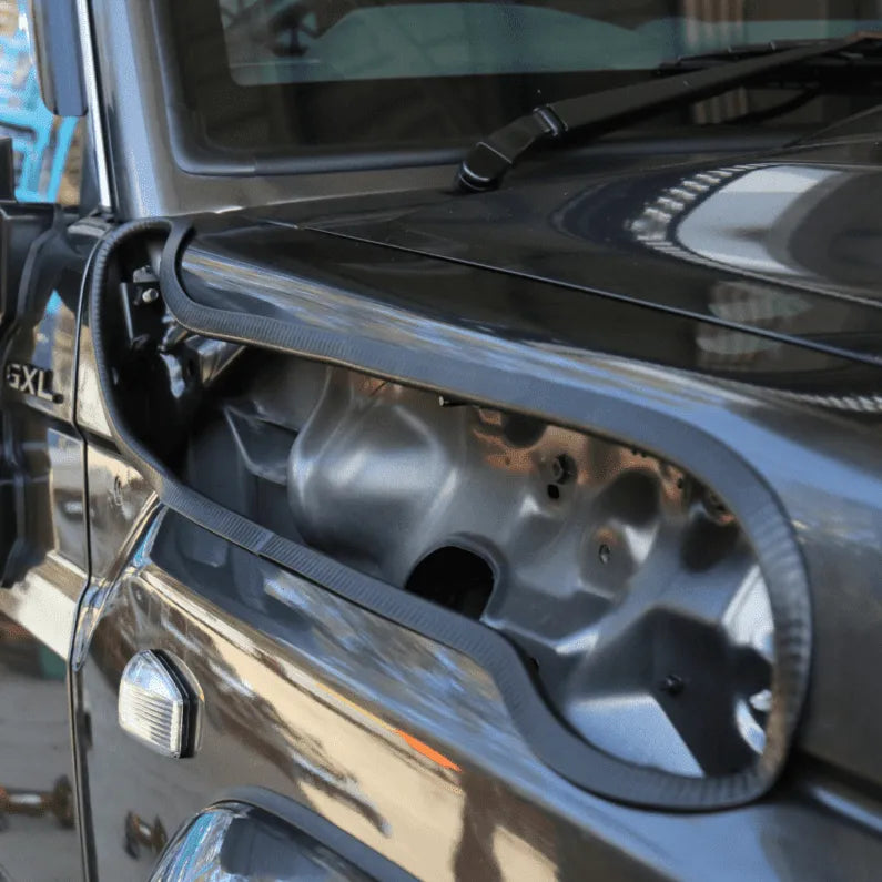 Close-up of a vehicle's side panel, on a blurred background.