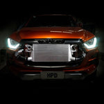 Orange car with a prominent intercooler on a dark background