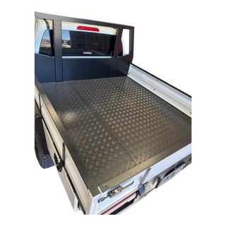 Empty truck bed with a checkered floor pattern on a white background – Dual Cab 1800mm Aluminium Tray with 1m Trundle Drawer 50L Water tank & Colour Coded Tray Sides