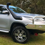 Silver SUV with off-road features on a grassy area