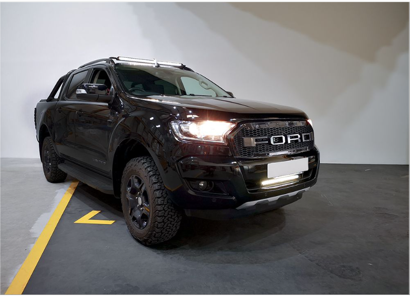 Black Ford truck parked indoors with a white wall background with Lazer Lamps Bumper Beam Mount Kit – Ford Ranger (2016–2022)