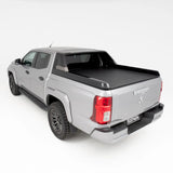 Silver pickup truck with a black tonneau cover on a white background