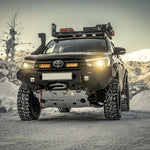 Toyota truck with off-road equipment in a snowy landscape
