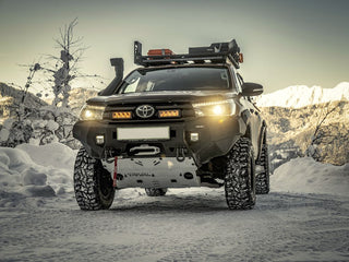 Toyota truck with off-road equipment in a snowy landscape