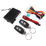 Car alarm system with control panel, remote controls, and wiring on a white background