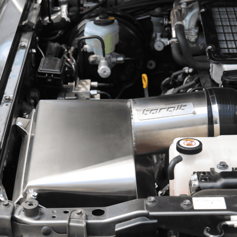 Close-up of a car engine with a torqit airbox system.