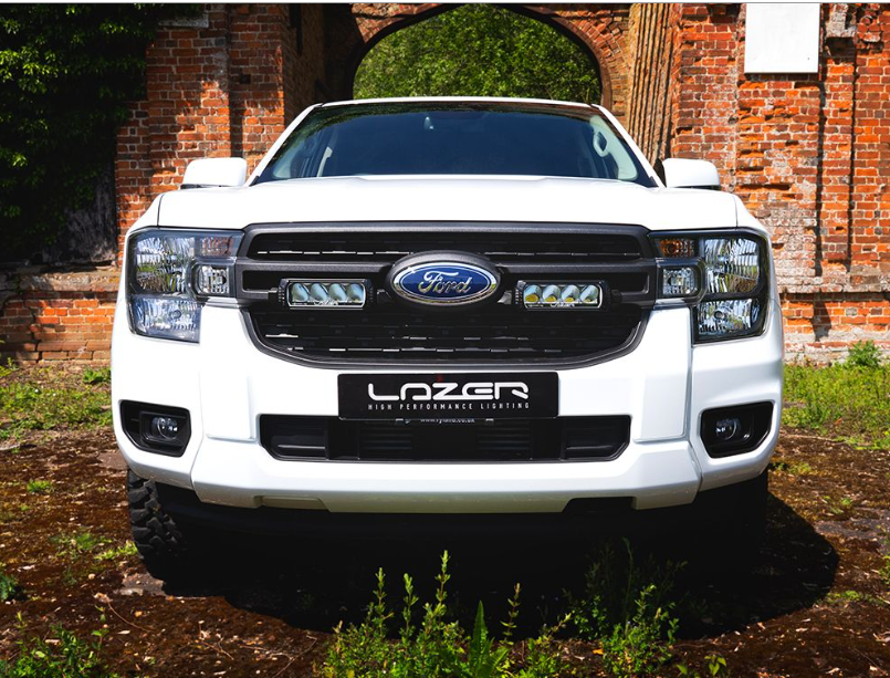 White Ford vehicle with LazerLamps Grille kit on a rustic background