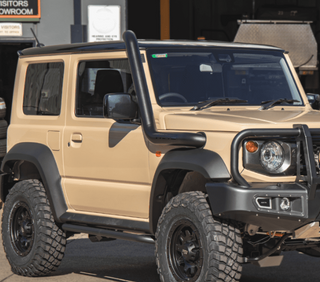Beige off-road vehicle with black roof rack and bumper in a showroom setting