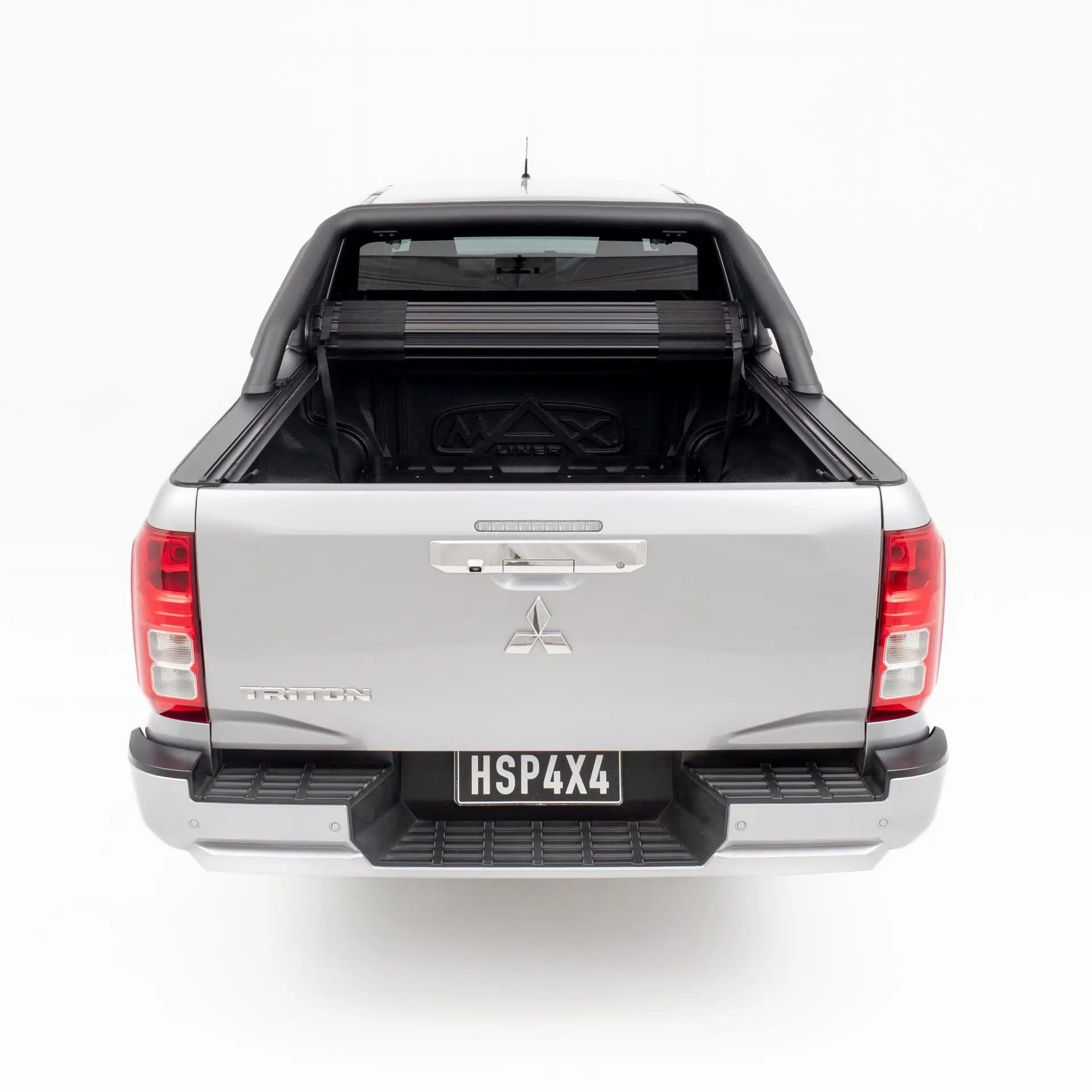Back view of a silver Mitsubishi pickup truck on a white background