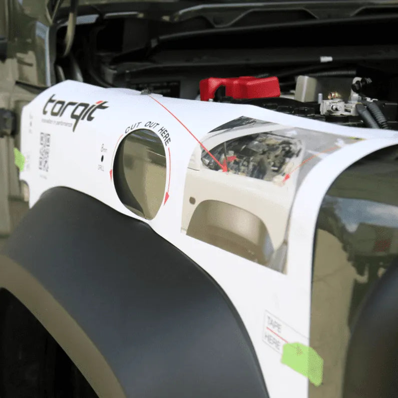 Car fender with a repair kit labeled 'torqit' on a car with an open hood.