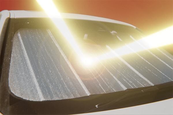 Close-up of a car's sunshade with sunlight filtering through