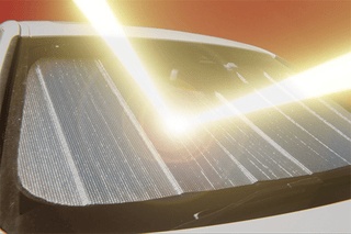 Close-up of a car's sunshade with sunlight filtering through