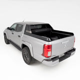 Silver pickup truck with a black tonneau cover on a white background