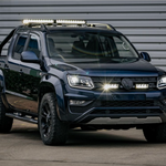 Black Volkswagen Amarok pickup truck with additional lights on a gray background with Lazer Lamps Grille Kit for VW Amarok V6 (2016–2022)