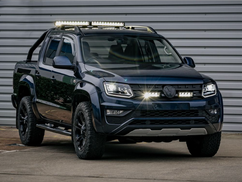 Black Volkswagen Amarok pickup truck with additional lights on a gray background with Lazer Lamps Grille Kit for VW Amarok V6 (2016–2022)