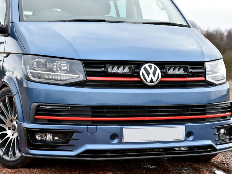 Front view of a blue Volkswagen van with a visible logo with Lazer Lamps Grille Kit for VW Transporter T6 Highline