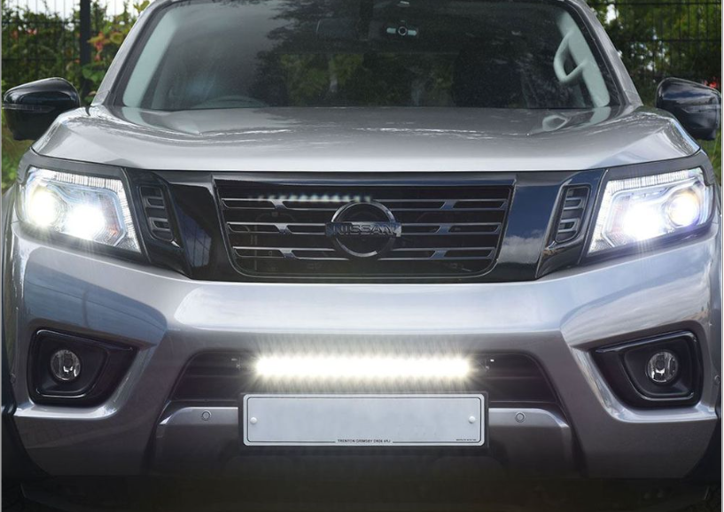 Front view of a silver Nissan vehicle with headlights on with Lazer Lamps Nissan Navara (2014-2021) Kit