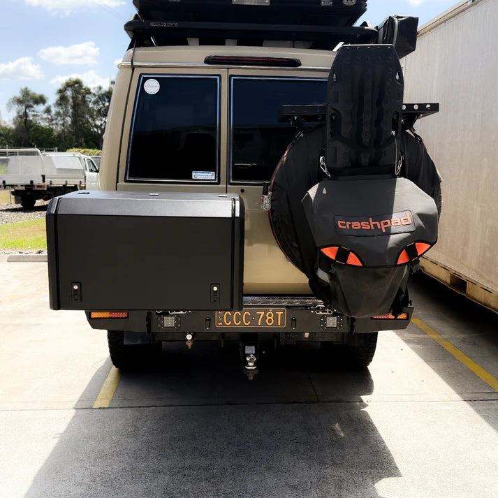Back view of a vehicle with a spare tire and 'crashpad' branding on a concrete surface.
