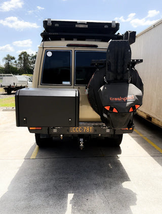 Back view of a vehicle with a spare tire and 'crashpad' branding on a concrete surface.