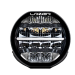 A black 7-inch Lazerlamps Sentinel LED driving light with a clear polycarbonate lens, designed for vehicles or tight mounting setups, featuring advanced LED technology.