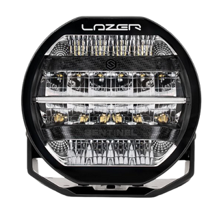 A black 7-inch Lazerlamps Sentinel LED driving light with a clear polycarbonate lens, designed for vehicles or tight mounting setups, featuring advanced LED technology.