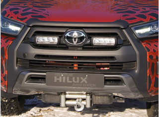 Front view of a Toyota Hilux with a colorful design on the hood.