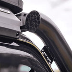 Roof rack system on a vehicle with visible brand logo.