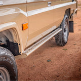 Beige off-road vehicle with a step bar on a dirt surface