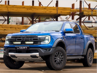 Blue Ford F-150 Raptor truck with LazerLamper Grille Kit on a construction site