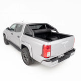Silver Mitsubishi Triton pickup truck with a black tonneau cover on a white background