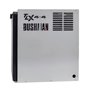 Side of a Bushman TX 4x4 fridge, the stainless panel carrying the Bushman name with the ventilation louvres and the condenser fins wrapping around the rear edge