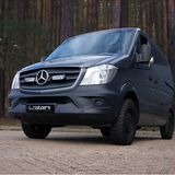 Black Mercedes-Benz van with 'Lozer' branding on a road with trees in the background with Lazer Lamps Mercedes Sprinter (2013-2017) Grille Kit