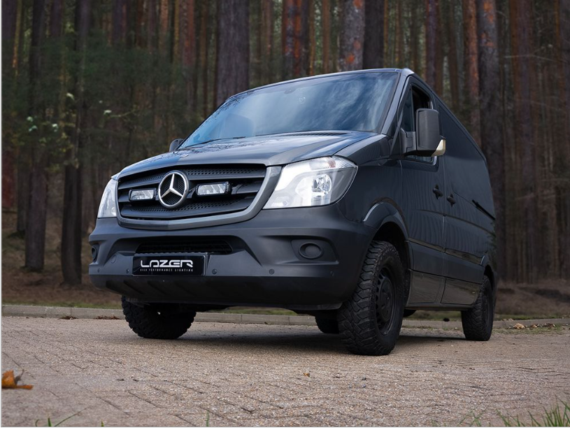 Black Mercedes-Benz van with 'Lozer' branding on a road with trees in the background with Lazer Lamps Mercedes Sprinter (2013-2017) Grille Kit