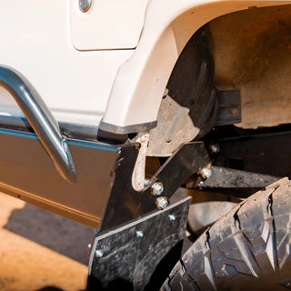 Close-up of a vehicle's undercarriage with a metal bumper and tire – TCC 78 Series Troop carrier Rear Bar Tow Bar