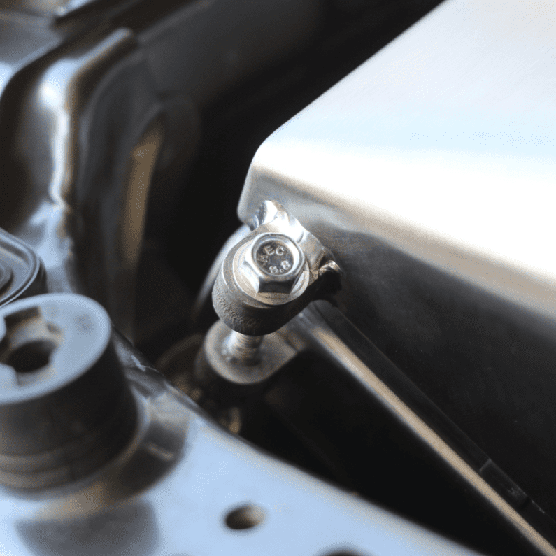 Close-up of a metal bolt and washer on a mechanical component.