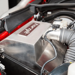 Close-up of a car engine with a 'torqit' branded component.