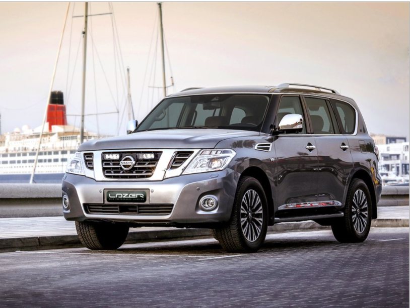 Silver Nissan Patrol SUV parked on a dock with a ship in the background with Lazer Lamps Nissan Patrol Y62 2018-2019  Grille Mount