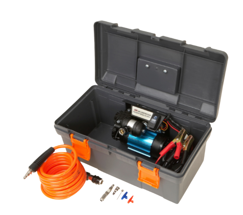 ARB single piston compressor in its grey plastic travel case with the lid open, the compressor mounted inside with its battery clamps, and the orange coiled air hose, tyre chuck and inflation adaptors laid out in front