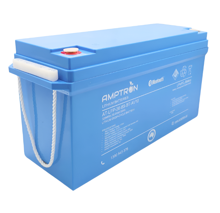 The same 36 volt 85Ah Amptron battery from the front corner with its rope carry handle lifted clear of the case, showing the depth of the housing and the recessed terminals