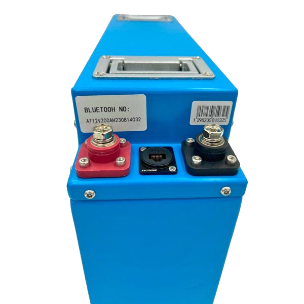 Top of the slimline battery showing the recessed carry handle, the red and black terminal blocks with their stainless bolts, and the sealed communication socket between them, with the Bluetooth serial number sticker alongside